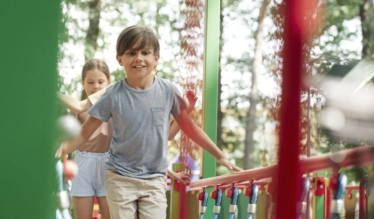 Group of kids playing at the playground in summer day