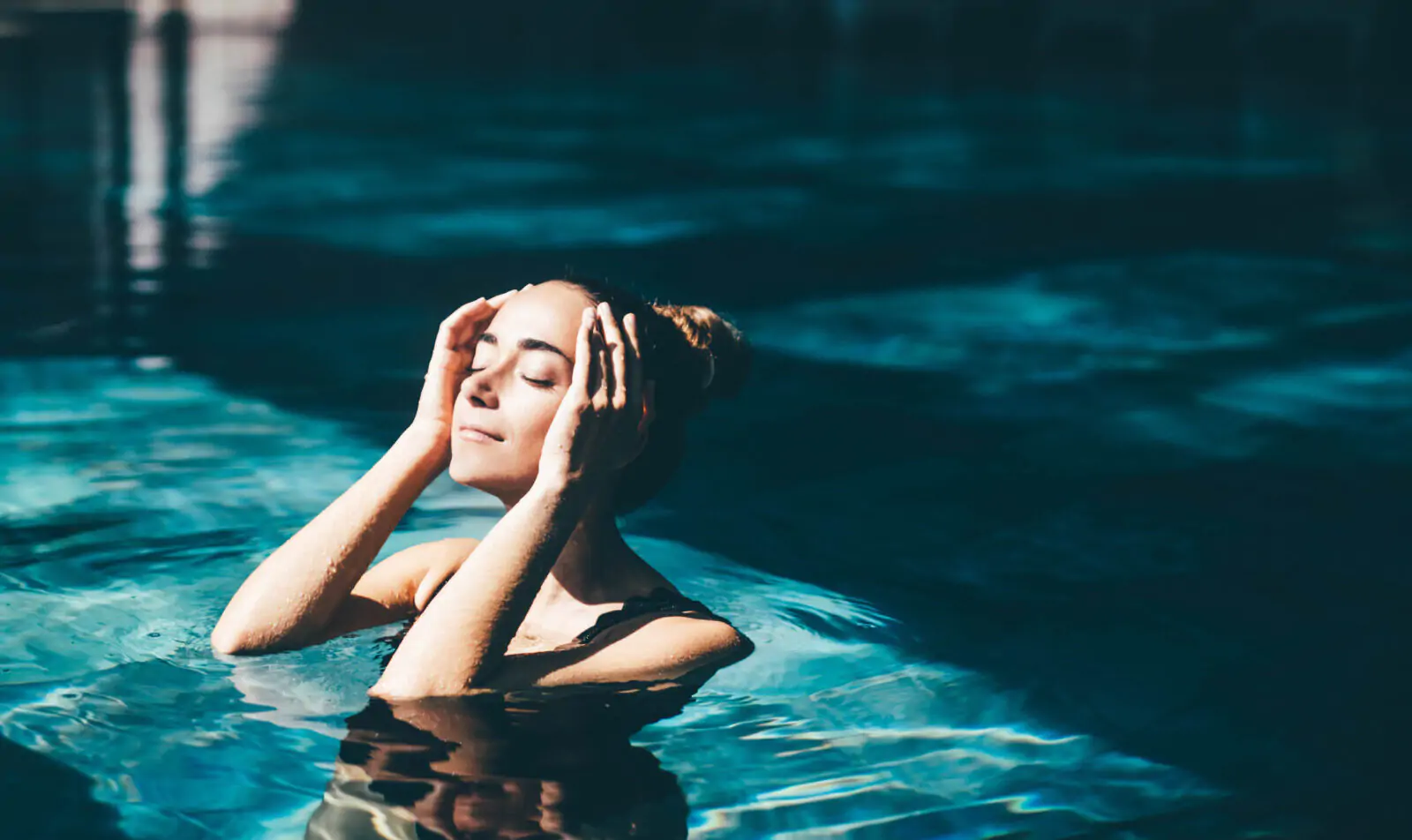 Woman relaxing in the swimming pool.