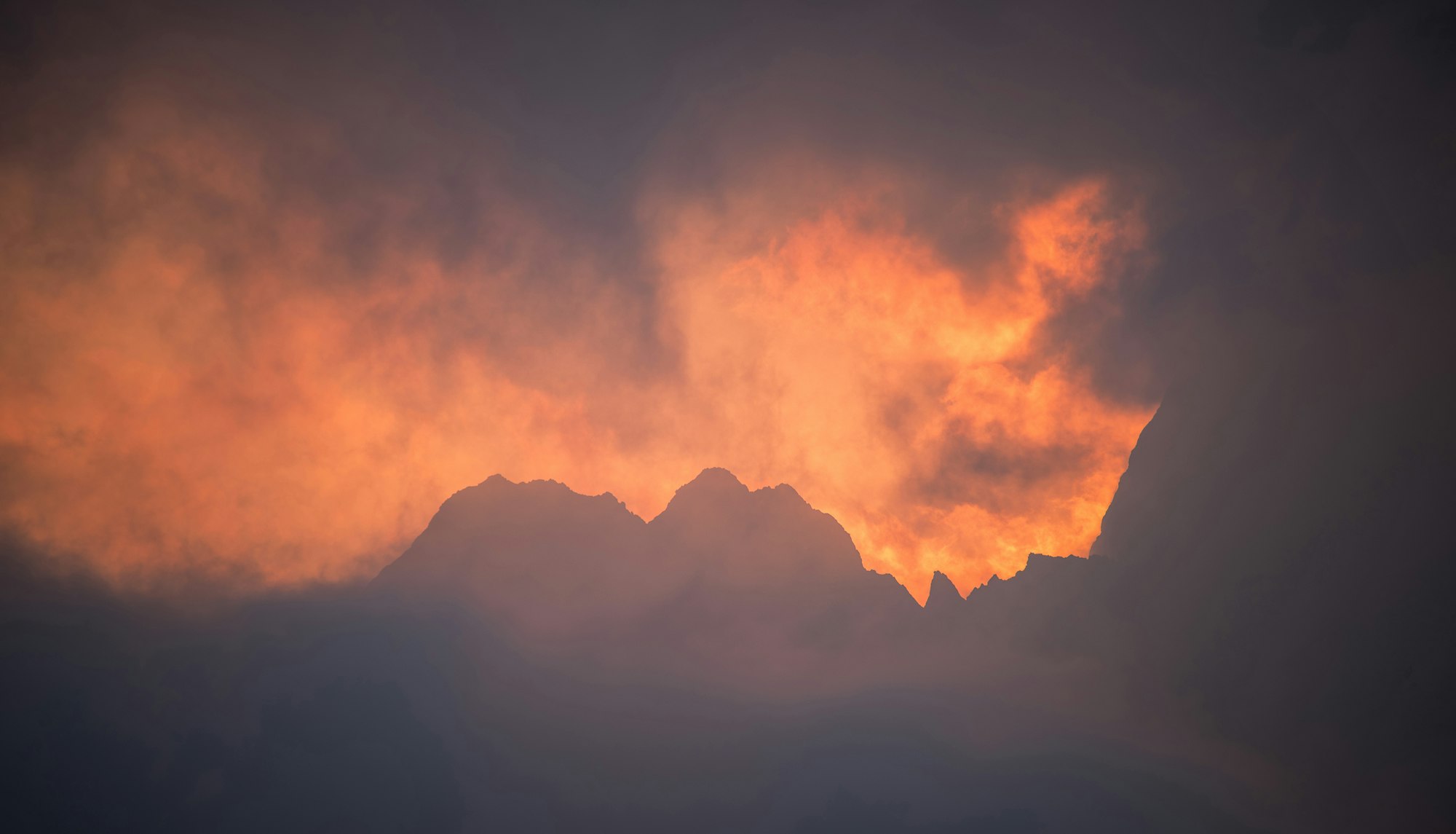 Burning fire at sunrise in the mountains