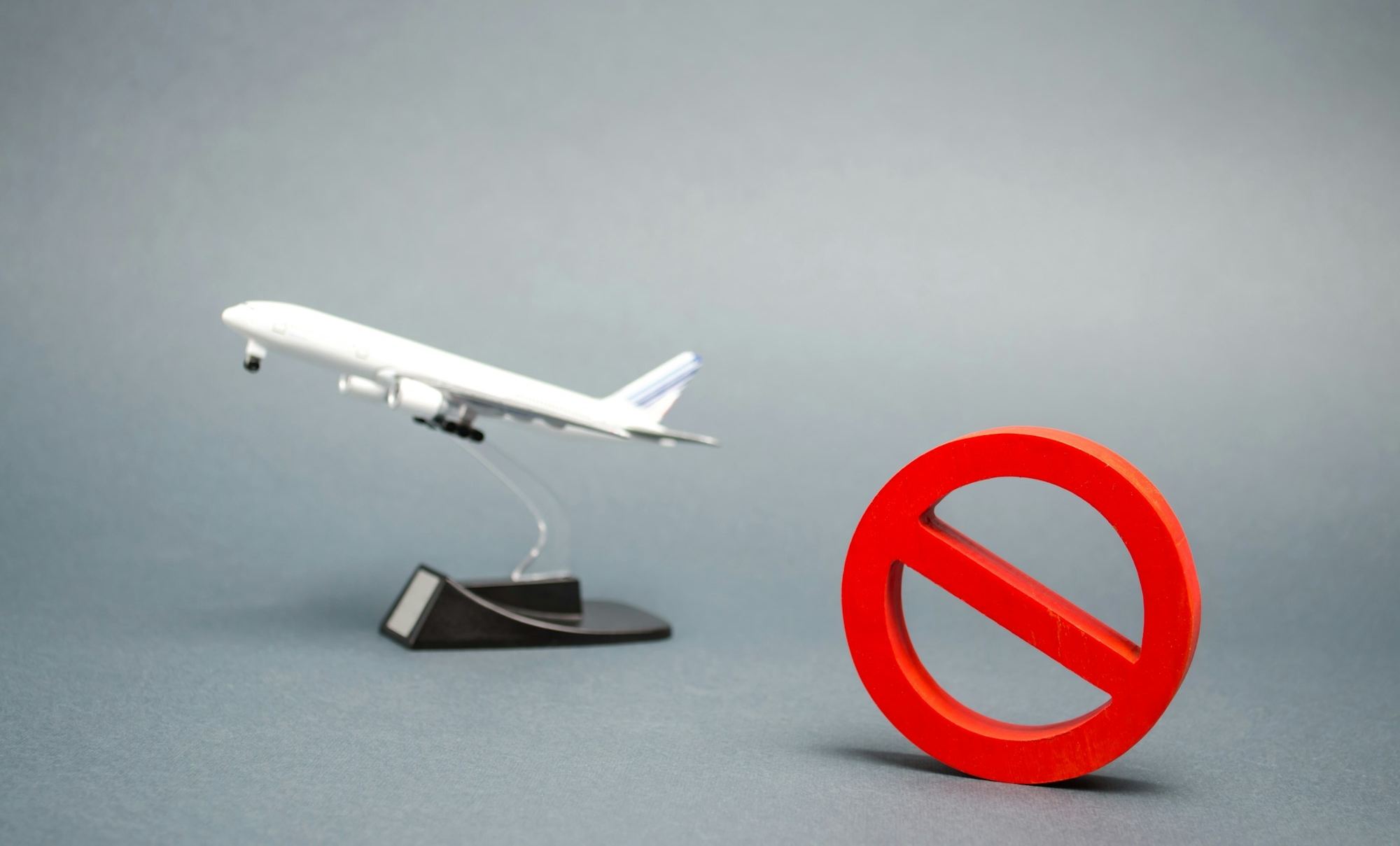The sign of the ban and a miniature toy aircraft
