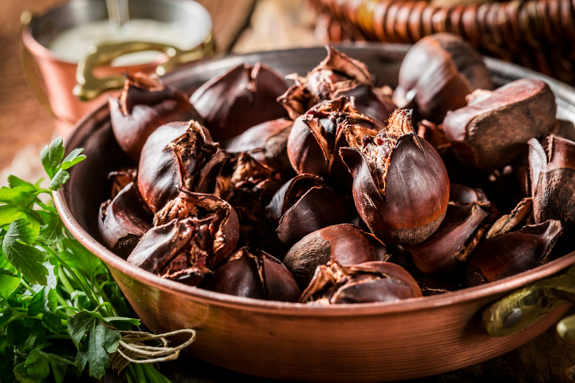 Homemade baked chestnuts on a copper pan