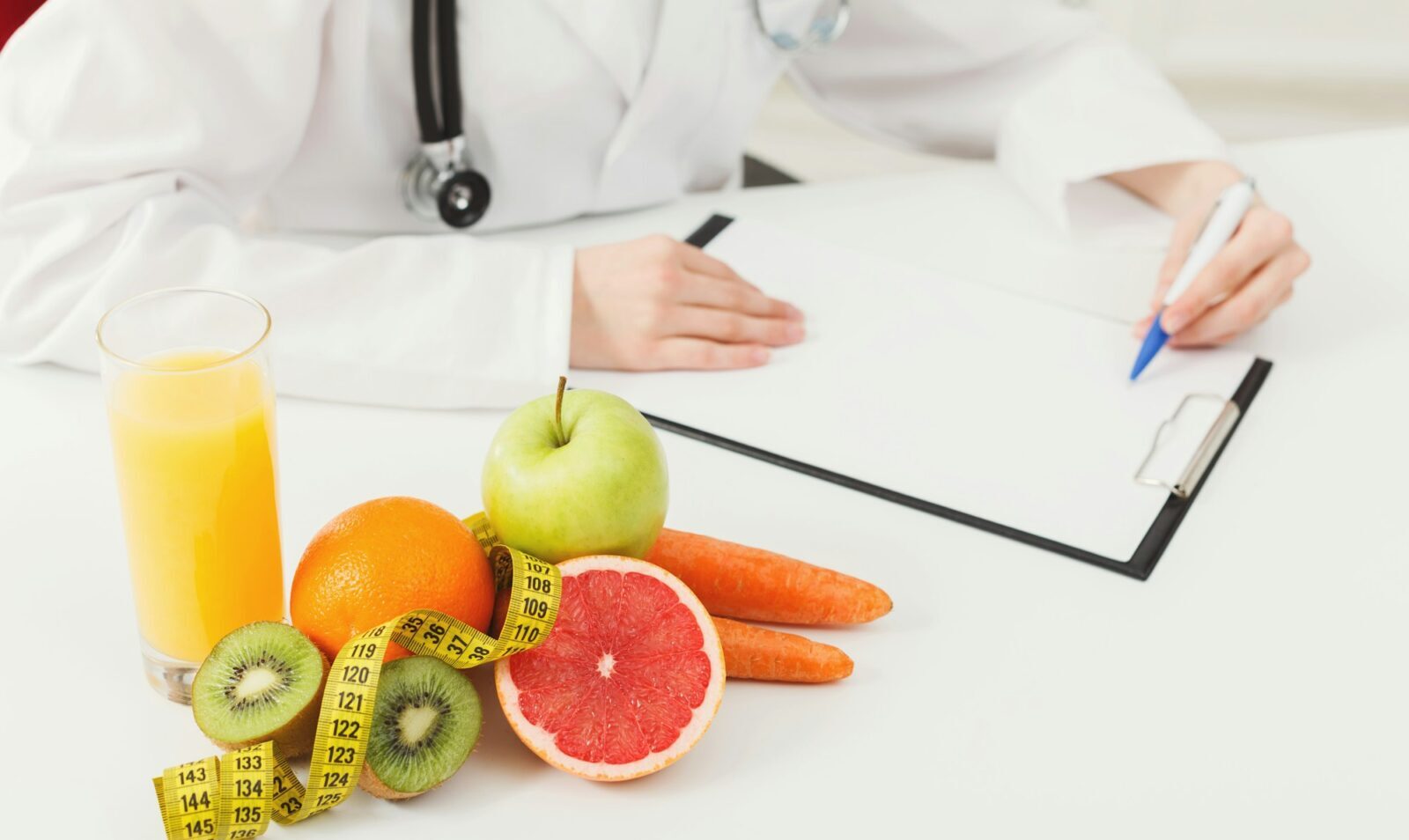 Nutritionist desk with fruit and measuring tape